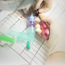 Veterinary dental Dentanomic Ergonomic Handle in pink, being used by a vet. These Dentanomic handles are easy to grip.